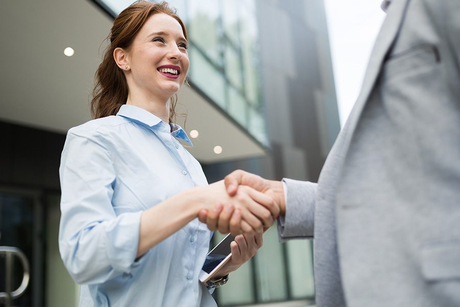 About Our Agency - Successful Business People Shaking Hands While Closing a Business Deal